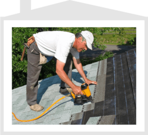 Roofing worker installing shingles